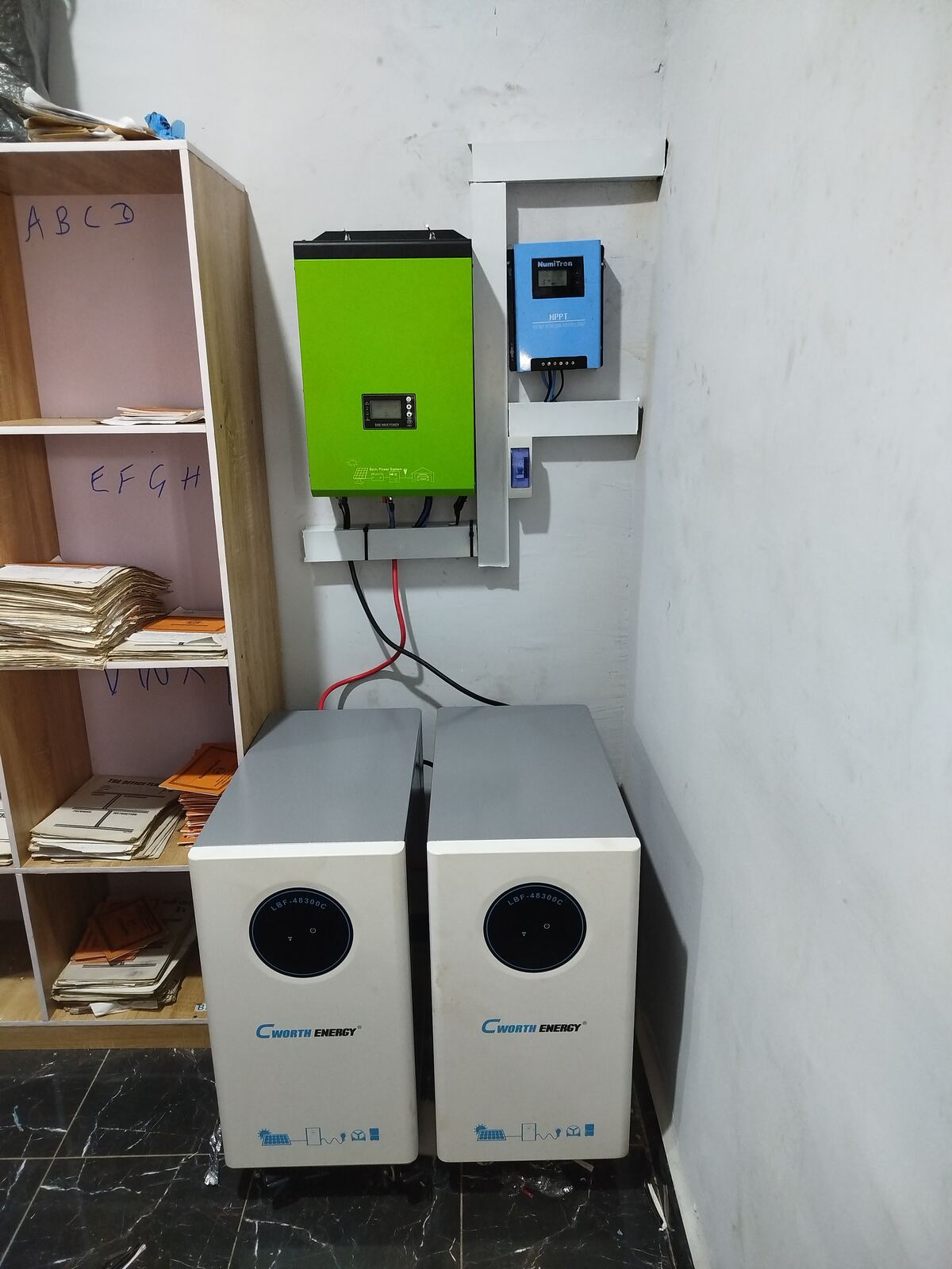 NumiTron MPPT controller, inverter, and batteries installed on a wall